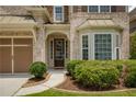 Close-up of the front entrance showing the door, manicured landscaping, and bay window at 4652 Prater Se Way, Smyrna, GA 30080