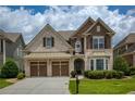 Attractive two-story home with a two-car garage, lush lawn, and inviting curb appeal at 4652 Prater Se Way, Smyrna, GA 30080