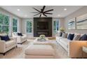 Bright living room with modern fireplace, plush seating, and large windows offering scenic views at 553 Somersby Dr, Dallas, GA 30157