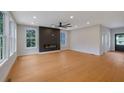 Spacious living room boasts hardwood floors, fireplace, and large windows with scenic views and ample light at 553 Somersby Dr, Dallas, GA 30157