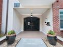 Secured building entrance with wrought iron gate and stylish potted plants at 1850 Cotillion Dr # 2416, Atlanta, GA 30338