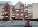 Apartment building showcasing brick facade, multiple stories, and private balconies at 1850 Cotillion Drive Dr # 2416, Atlanta, GA 30338