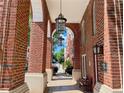 Arched brick walkway featuring hanging lanterns and a bench for residents and visitors at 1850 Cotillion Drive Dr # 2416, Atlanta, GA 30338