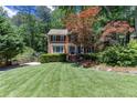 Well-maintained two-story brick home with lush green lawn and basketball hoop at 2122 Rockland Ct, Marietta, GA 30062