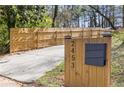 Driveway entrance with wooden fence and mailbox with home address at 2453 Paul Nw Ave, Atlanta, GA 30318