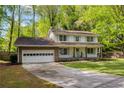 Charming two-story home with a brick garage, well-manicured lawn, and beautiful landscaping at 3719 Northbrook Ct, Atlanta, GA 30340