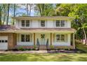Inviting two-story home with a classic front porch, lush lawn, and well-maintained landscaping at 3719 Northbrook Ct, Atlanta, GA 30340