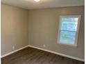 Bright bedroom with hardwood flooring, natural light, and neutral walls at 633 Tom Read Dr, Marietta, GA 30062
