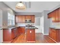 Traditional kitchen with cherry wood cabinets, stainless steel appliances, granite countertops, and wood flooring, ready for cooking at 3704 Ramsey Sw Cir, Atlanta, GA 30331