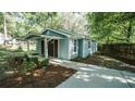 Home featuring a covered front porch, concrete walkway, and side yard landscaping at 4443 Toonigh Nw Rd, Acworth, GA 30101