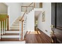 Bright foyer featuring hardwood floors, staircase and white walls at 5013 Kendall Nw Sta, Acworth, GA 30102