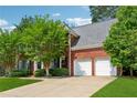 Brick home exterior with an attached two car garage and well-maintained lawn at 5013 Kendall Nw Sta, Acworth, GA 30102