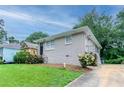 Charming single-story home featuring a well-kept lawn, dark door and lush landscaping at 933 Capitol View Nw Ave, Atlanta, GA 30318