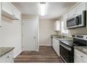 Modern kitchen featuring stainless steel appliances, granite countertops, and wood flooring at 933 Capitol View Nw Ave, Atlanta, GA 30318