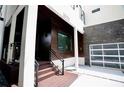 View of home's entrance with custom wood facade and modern glass garage door at 1099 Vista Ne Trl, Atlanta, GA 30324