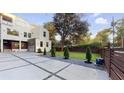 A modern white home featuring a geometric driveway, beautiful lawn and privacy fence at 1099 Vista Ne Trl, Atlanta, GA 30324