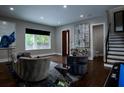 Inviting living area with hardwood floors, stylish seating, and bright natural light from a large window at 1099 Vista Ne Trl, Atlanta, GA 30324