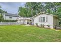 Exterior view of the property showcasing the lovely lawn and picket fence on a cloudy day at 1652 Tryon Ne Rd, Atlanta, GA 30319