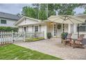 Inviting front entrance with stone patio, outdoor seating, and a charming front door with wreath at 1652 Tryon Ne Rd, Atlanta, GA 30319