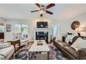 Cozy living room with hardwood floors, fireplace, ceiling fan, and comfortable seating at 1652 Tryon Ne Rd, Atlanta, GA 30319