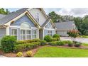 Charming single-Gathering home with manicured lawn and garden, and architectural details at 18 Mary Ne Ln, White, GA 30184