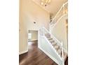 Bright entryway featuring a staircase with white railings, hardwood floors and a chandelier at 759 Hennepin Ter, Mcdonough, GA 30253