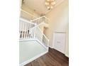 Bright interior showcasing a staircase with white railings, hardwood floors, and neutral-toned walls at 759 Hennepin Ter, Mcdonough, GA 30253