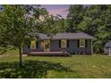 Charming single-story home with a well-maintained lawn and a cozy front porch at 130 Driver St, Temple, GA 30179