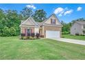 Attractive single-Gathering home featuring a well-maintained lawn and a spacious two-car garage at 1431 Beckett Dr, Hampton, GA 30228