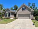 Beautiful home with a two-car garage, brick accents, manicured lawn, and well-maintained landscaping at 3165 Blackshear Dr, Marietta, GA 30060