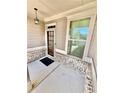 Inviting porch with brick accents, a stylish light fixture, and a view of the landscaped yard at 3165 Blackshear Dr, Marietta, GA 30060