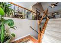 The staircase has wood and iron accents, and is flooded with light from nearby windows at 435 Flowering Trl, Grayson, GA 30017