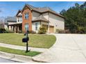 Attractive home featuring a long driveway, attached garage, and a neatly kept lawn at 533 Mount Gerizim Se Rd, Mableton, GA 30126