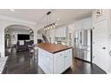 Eat-in kitchen with stainless appliances, center island, and view into the adjacent living area at 6310 Stillwood Ln, Cumming, GA 30041