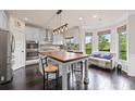 Modern kitchen with stainless steel appliances, island with bar stools, and a cozy eating nook at 6310 Stillwood Ln, Cumming, GA 30041