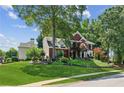 Beautiful two-story brick home with a well-manicured lawn, mature trees, and charming curb appeal at 750 Highview Ct, Woodstock, GA 30189