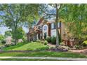 Picturesque brick home featuring a lush front lawn and attractive landscaping, enhancing its curb appeal at 750 Highview Ct, Woodstock, GA 30189