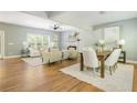 Open concept living room and dining area with hardwood floors, a stone fireplace, and ample natural light at 1496 Shadowrock Dr, Marietta, GA 30062