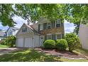 Charming two-story home with a manicured lawn, brick accents, gray shutters and a two-car garage at 2908 Cottesford Se Way, Smyrna, GA 30080