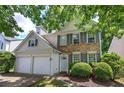 Charming two-story home with a manicured lawn, brick accents, gray shutters and a two-car garage at 2908 Cottesford Se Way, Smyrna, GA 30080