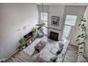 Bright living room featuring a fireplace, high ceilings, ceiling fan and large windows at 2908 Cottesford Se Way, Smyrna, GA 30080