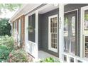 Inviting front porch with brick accents and well-maintained landscaping at 402 Roswell Green Ln, Roswell, GA 30075