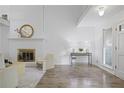 Bright living room with a painted brick fireplace at 402 Roswell Green Ln, Roswell, GA 30075