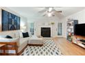 Bright living room with a fireplace, hardwood floors, and a cozy seating area at 1412 Oakridge Cir, Decatur, GA 30033
