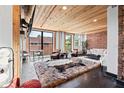 Open living room with wood ceiling, brick accents and oversized windows allows for an abundance of natural light at 87 Peachtree Sw St # 209, Atlanta, GA 30303