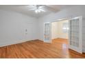 Bedroom featuring hardwood floors, white walls, and French doors leading to another room at , Atlanta, GA 30306