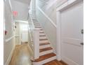 Hallway with hardwood floors, staircase, door and an exit sign at , Atlanta, GA 30306