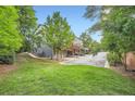 Lush backyard with mature trees and a view of townhome exteriors and garages at 2300 Whiteoak Drive Southeast Se Dr, Smyrna, GA 30080