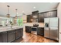 Modern kitchen with stainless steel appliances, dark cabinets, and hardwood floors at 2300 Whiteoak Drive Southeast Se Dr, Smyrna, GA 30080