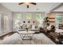 Bright living room featuring stylish furniture, three windows, and a ceiling fan at 2300 Whiteoak Drive Southeast Se Dr, Smyrna, GA 30080